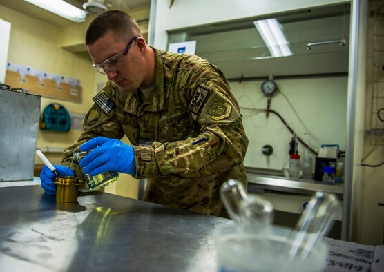 U.S. Air Force Tech. Sgt. Matthew Copley, NCS Fuels Laboratory supervisor, prepares fuel for testing, March 20, 2013, in Kabul, Afghanistan. Copley is responsible for testing jet and diesel fuel for the International Security Assistance Force. Copley, a native of Parkersburg, W.V., is a technical school instructor deployed from the 364th Training Squadron, Sheppard Air Force Base, Texas. (U.S. Air Force photo by Staff Sgt. Marleah Miller)