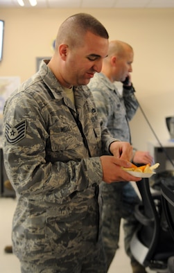 Tech. Sgt. Matthew Weekly, Air Forces Central Command air transportation, eats freshly made guacamole May 3 at an undisclosed location in Southwest Asia. (U.S. Air Force photo by Staff Sgt. Rachelle Elsea) 
