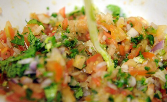 Freshly-made Pico de Gallo is mixed with smashed avocados to create guacamole. (U.S. Air Force photo by Staff Sgt. Rachelle Elsea)