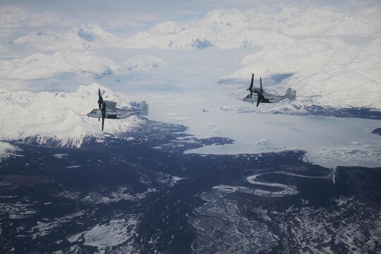Two MV22B Ospreys with Marine Medium Tiltrotor Squadron 161 fly over Alaskan mountains on thier flight to Anchorage, Alaska.  The Ospreys flew out to meet and support the USS Anchorage during public tours and the ship's commissioning ceremony May 4.  VMM-161 is the first squadron of Ospreys to make the trip to Alaska.