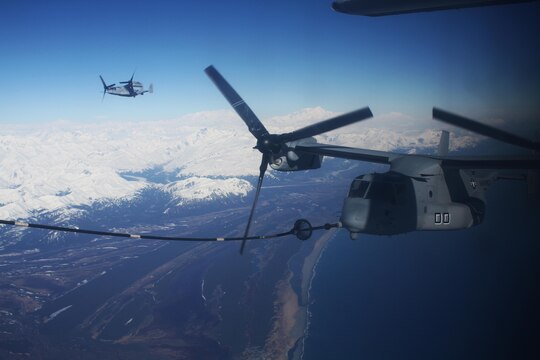An MV22B Osprey with Marine Medium Tiltrotor Squadron 161 recieves a mid-flight refueling while flying to Anchorage, Alaska to meet up with and support the USS Anchorage during public tours and the ship's commissioning ceremony May 4.  VMM-161 is the first squadron of Ospreys to make the trip to Alaska.