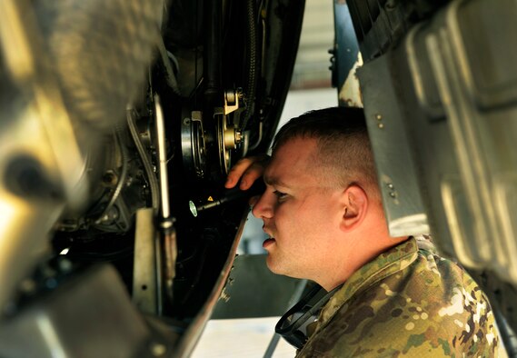 Petty Officer Second Class John Foster, Navy Expeditionary Logistics Support Group customs officer, inspects a C-130 Hercules engine for stagnant water, vegetation, insects and contraband on Bagram Airfield, Afghanistan, May 13, 2013. Once the engine is cleared it will be brought to the Transportation Management office for shipment back to the United States. (U.S. Air Force photo/ Staff Sgt. Stephenie Wade)