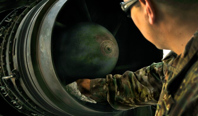 Staff Sgt. Christopher Contreras, 455th Aircraft Maintenance Squadron C-130 maintainer, cleans dirt and water out of an engine, prior to a customs inspection on Bagram Airfield, Afghanistan, May 13, 2013. The engine must be clean of dirt, water, insects and vegetation prior to customs approving it for shipment. Contreras is deployed from Little Rock Air Force Base, Ark. (U.S. Air Force photo/Staff Sgt. Stephenie Wade)