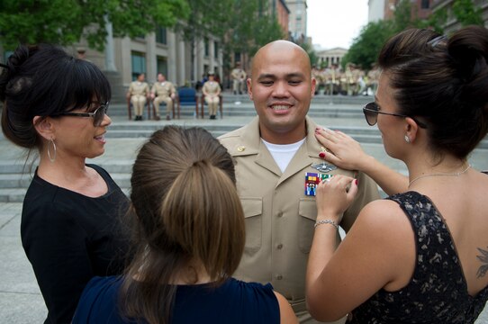 Chief Hospital Corpsman Joseph Santos, the 2012 Pacific Fleet Sailor of the Year, has his anchors pinned on by his family during the 2012 Sailor of the Year Pinning Ceremony. Santos and three other 2012 Sailors of the Year were meritoriously promoted to chief petty officer during the ceremony by Vice Chief of Naval Operations Adm. Mark E. Ferguson.