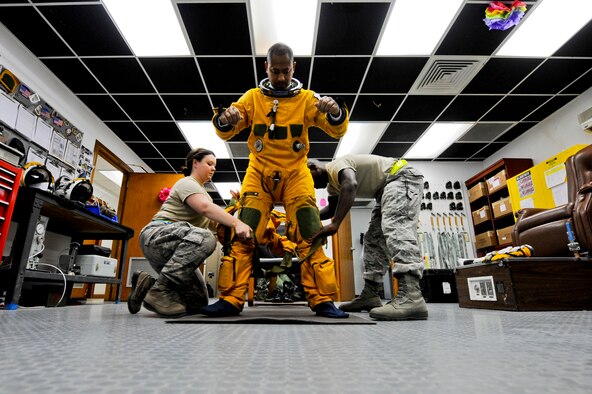 U.S. Air Force Staff Sgt. Heather Doyle, 99th Expeditionary Reconnaissance Squadron aerospace physiology technician, and U.S. Air Force Staff Sgt. Joshua Thornton, 99th ERS life support technician, help U.S. Air Force Maj. Patrick Hudson, 99th ERS U-2 pilot, get into his full pressure suit prior to Hudson's final combat sortie, May 17, 2013, at an undisclosed location in Southwest Asia. Hudson is the 31st pilot in the U-2 program to reach 2,000 U-2 flying hours. Hudson hails from Fayette, Miss., and is deployed from Beale Air Force Base, Calif. Thornton is native to Minden, La., and is also deployed from Beale AFB, as is Doyle. (U.S. Air Force photo by Staff Sgt. Joshua J. Garcia)