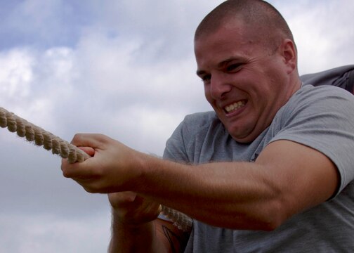Sgt. Jonathon Barnhart, clinches his teeth as he and his team attempt to win a tug-of-war match during the safety fair and field meet held at Lake O’Neill Recreational Area here May 17. Barnhart is a radar technician with Headquarters and Headquarters Squadron at the Marine Corps Air Station here.