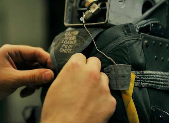 Senior Airman Garron Theriault, 455th Expeditionary Maintenance Squadron egress technician, tests the elasticity of the parachute enclosure straps during an inspection on Bagram Airfield, Afghanistan, May 17, 2013. Aircrew egress system technicians ensure the safety of 74th Expeditionary Fighter Squadron pilots by inspecting and performing preventative maintenance on the egress systems and components of the A-10 Thunderbolt II. Theriault is from Harrison, Maine. ( U.S. Air Force photo/ Staff Sgt/ Stephenie Wade) 
