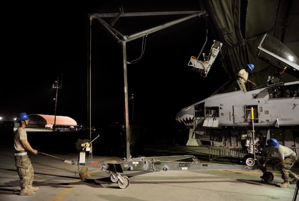 (Left to Right) Airman 1st Class Mark Armstrong, Staff Sgt. Keith Billings and Senior Airman Garron Theriault, 455th Expeditionary Maintenance Squadron egress technicians, remove an Advanced Concept Ejection System from an A-10 Thunderbolt II aircraft on Bagram Airfield, Afghanistan, May 17, 2013. Egress technicians are responsible for all the components involved with the pilot’s ejection system. The A-10 is a specialized ground-attack aircraft which provides close air support to ground forces operating in Afghanistan. Armstrong, Billings and Theriault are all deployed from Moody Air Force Base, Ga. ( U.S. Air Force photo/ Staff Sgt/ Stephenie Wade) 