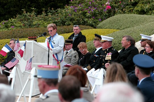The mayor of the village of Belleau, Monique Benier, addresses the U.S. Marines, French troops, locals of the village of Belleau and visitors from around the world during the Memorial Day ceremony, May 26. To celebrate Memorial Day, and to mark the 95th anniversary of the historic Battle of Belleau Wood, U.S. Marines with their French counterparts gathered at Aisne-Marne American Cemetery to commemorate their fallen heroes, May 26. The event was held in the memorial cemetery that lies outside of the historic grounds of Belleau Wood and featured the laying of wreathes, a firing of volleys, the playing of TAPS, raising of the American and French national colors, and a concert by the French military band. The mayor of the village of Bellau along with other military officers and officials representing the U.S. and France were present. Participating units from the U.S. Marines included 5th Marine Regiment, Marine Security Guard Detachment, the Wounded Warrior Regiment and Marine Forces Europe and Africa. French units that participated in the ceremony included the 21st Marine Infantry Regiment and the Musique Principale des Troupes de Marines. 
