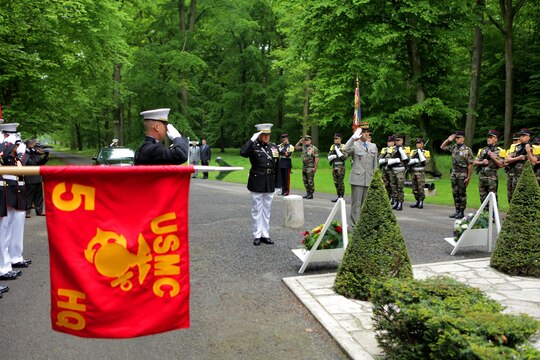 After laying wreathes at the “Iron Mike” statue that lie in the woods of Belleau, Major General Raymond C. Fox, commanding general of Marine Forces Africa and II Marine Expeditionary Force, and French General Francis Autran, deputy chief of staff of “Plans and Programmes” at the French Army Staff, salute in tribute prior to the Memorial Day ceremony, May 26. To celebrate Memorial Day, and to mark the 95th anniversary of the historic Battle of Belleau Wood, U.S. Marines with their French counterparts gathered at Aisne-Marne American Cemetery to commemorate their fallen heroes, May 26. The event was held in the memorial cemetery that lies outside of the historic grounds of Belleau Wood and featured the laying of wreathes, a firing of volleys, the playing of TAPS, raising of the American and French national colors, and a concert by the French military band. The mayor of the village of Bellau along with other military officers and officials representing the U.S. and France were present. Participating units from the U.S. Marines included 5th Marine Regiment, Marine Security Guard Detachment, the Wounded Warrior Regiment and Marine Forces Europe and Africa. French units that participated in the ceremony included the 21st Marine Infantry Regiment and the Musique Principale des Troupes de Marines. 
