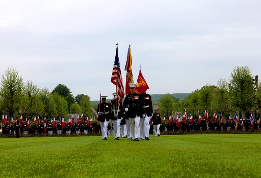 The Marine detachment from the 5th Marine Regiment enters the parade field of Aisne-Marne American Cemetery for the Memorial Day event, May 26. To celebrate Memorial Day, and to mark the 95th anniversary of the historic Battle of Belleau Wood, U.S. Marines with their French counterparts gathered at Aisne-Marne American Cemetery to commemorate their fallen heroes, May 26. The event was held in the memorial cemetery that lies outside of the historic grounds of Belleau Wood and featured the laying of wreathes, a firing of volleys, the playing of TAPS, raising of the American and French national colors, and a concert by the French military band. The mayor of the village of Bellau along with other military officers and officials representing the U.S. and France were present. Participating units from the U.S. Marines included 5th Marine Regiment, Marine Security Guard Detachment, the Wounded Warrior Regiment and Marine Forces Europe and Africa. French units that participated in the ceremony included the 21st Marine Infantry Regiment and the Musique Principale des Troupes de Marines. 
