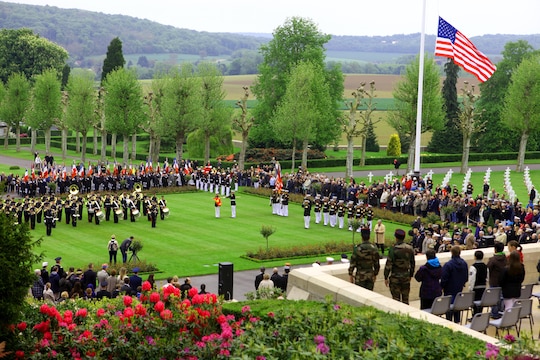 The Memorial Day ceremony at Aisne-Marne American Cemetery as seen from the woods of Belleau, the historic battlegrounds of The Battle of Belleau Wood, May 26. To celebrate Memorial Day, and to mark the 95th anniversary of the historic Battle of Belleau Wood, U.S. Marines with their French counterparts gathered at Aisne-Marne American Cemetery to commemorate their fallen heroes, May 26. The event was held in the memorial cemetery that lies outside of the historic grounds of Belleau Wood and featured the laying of wreathes, a firing of volleys, the playing of TAPS, raising of the American and French national colors, and a concert by the French military band. The mayor of the village of Bellau along with other military officers and officials representing the U.S. and France were present. Participating units from the U.S. Marines included 5th Marine Regiment, Marine Security Guard Detachment, the Wounded Warrior Regiment and Marine Forces Europe and Africa. French units that participated in the ceremony included the 21st Marine Infantry Regiment and the Musique Principale des Troupes de Marines. 

