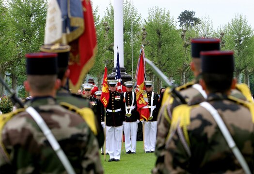 Marines from the 5th Marine Regiment stand at parade-rest during the Memorial Day ceremony at Aisne-Marne American Cemetery, May 26. To celebrate Memorial Day, and to mark the 95th anniversary of the historic Battle of Belleau Wood, U.S. Marines with their French counterparts gathered at Aisne-Marne American Cemetery to commemorate their fallen heroes, May 26. The event was held in the memorial cemetery that lies outside of the historic grounds of Belleau Wood and featured the laying of wreathes, a firing of volleys, the playing of TAPS, raising of the American and French national colors, and a concert by the French military band. The mayor of the village of Bellau along with other military officers and officials representing the U.S. and France were present. Participating units from the U.S. Marines included 5th Marine Regiment, Marine Security Guard Detachment, the Wounded Warrior Regiment and Marine Forces Europe and Africa. French units that participated in the ceremony included the 21st Marine Infantry Regiment and the Musique Principale des Troupes de Marines. 
