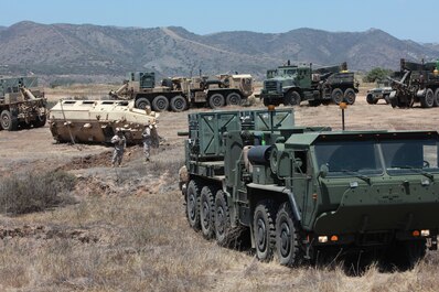 Wrecker operators with Maintenance Company, 1st Maintenance Battalion, Combat Logistics Regiment 15, 1st Marine Logistics Group, conduct a vehicle-recovery exercise during their sustainment training aboard Camp Pendleton, Calif., May 20, 2013. The training simulated the recovery of a vehicle disabled by an improvised explosive device. (U. S. Marine Corps photo by Lance Cpl. Cody Haas/Released)