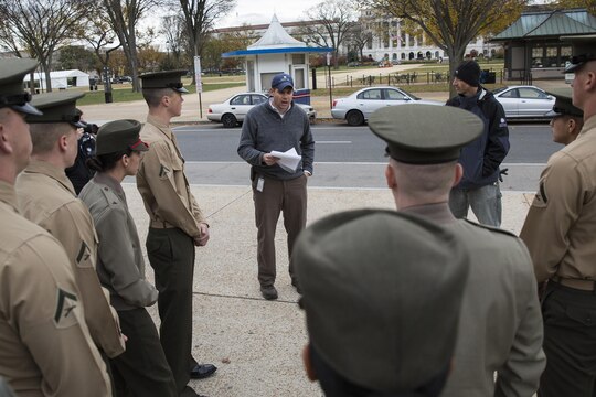 Brett McNish, Smithsonian Gardens supervisory horticulturist, gives Marines with Marine Barracks Washington, D.C., a short history brief about the significance of the poppy plant as it relates to the military and World War I in front of the National Museum of American History in Washington, Nov. 12. After the lesson, the Marines participated in the Flanders Field Project, where they spread seeds over the front lawn of the museum to recreate the poppy fields that blossomed on the war-stricken land of Europe in the aftermath of WWI.