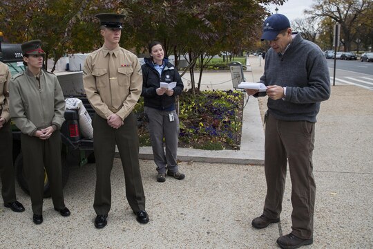 Brett McNish, Smithsonian Gardens supervisory horticulturist, gives Marines with Marine Barracks Washington, D.C., a short history brief about the significance of the poppy plant as it relates to the military and World War I in front of the National Museum of American History in Washington, Nov. 12. After the lesson, the Marines participated in the Flanders Field Project, where they spread seeds over the front lawn of the museum to recreate the poppy fields that blossomed on the war-stricken land of Europe in the aftermath of WWI.