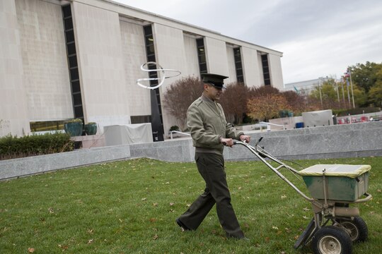 Lance Cpl. Jacobo Linares, a Marine with Marine Corps Institute Company, Marine Barracks Washington, D.C., sews seeds on the front lawn on the National Museum of American History as part of the Flanders Field Project in Washington Nov. 12. The project’s goal is to recreate the poppy fields that blossomed on the war-stricken land of Europe in the aftermath of WWI by spreading seeds over the front lawn of the museum.