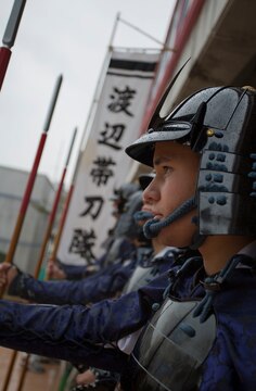 Cpl. James R. Smith, combat correspondent with the Public Affairs Office, aboard Marine Corps Air Station Iwakuni, Japan stands in formation, Nov. 17 2013, awaiting the start of the march towards the plaza where the samurai performed their reenactment. This event reenacts a battle that occurred during the 16th century in Kuga, Iwakuni City, Japan.