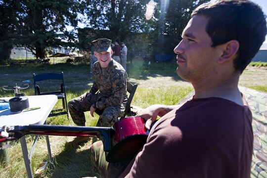 Pvt. Kereti Edwards, signaler with 2 Signal Squadron, from Tauranga, New Zealand jokes with Sgt. Greg Wubben, a civil affairs non-commissioned officer with 1st Civil Affairs Group, I Marine Expeditionary Force, from Ridgefield, Wash., in the field during exercise Southern Katipo 2013 aboard Timaru, New Zealand, Nov. 16. SK13 is designed to improve participating forces’ combat training, readiness and interoperability as part of a Joint Inter-Agency Task Force. 