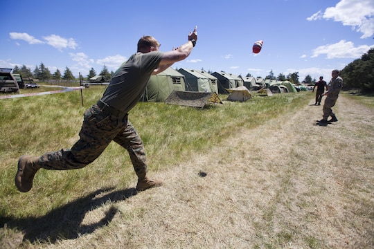 Sgt. Greg Wubben, a civil affairs non-commissioned officer with 1st Civil Affairs Group, I Marine Expeditionary Force, from Ridgefield, Wash., learns how to throw a rugby ball for the first time in the field during exercise Southern Katipo 2013 aboard Timaru, New Zealand, Nov. 16. SK13 allows our service members to collaborate with partner countries to achieve mutual security goals, address shared concerns and continue to enhance our interoperability. 