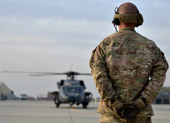 U.S. Air Force Airman 1st Class Josh Lombardo, 83rd Expeditionary Rescue Squadron crew chief, prepares to marshall a HH-60G Pave Hawk at Bagram Airfield, Afghanistan Nov. 22, 2013. The 83rd ERQS utilizes the Pave Hawk to accomplish their assault, secure and dominate rescue objectives. (U.S. Air Force photo by Senior Airman Kayla Newman/Released)