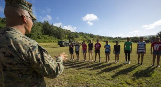 Staff Sgt. Jose R. Camberos from Los Angeles, Cali., teaches military troop movement to cadets to instill discipline Nov. 22 at the Tinian Junior Senior High School Junior Reserve Officers’ Training Corps field. Cadets from TJSHS JROTC partook in a field meet with Marines and sailors to build camaraderie between one another. Camberos is operations chief of heavy equipment with Marine Wing Support Squadron 171, Marine Aircraft Group 12, 1st Marine Aircraft Wing, III Marine Expeditionary Force.