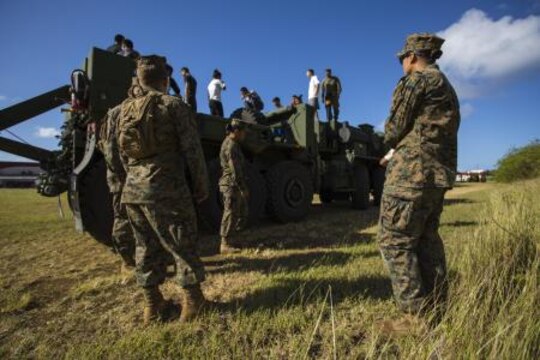 Marines give classes to cadets on the abilities and characteristics on the Logistical Vehicle Systems Replacement 15 to better help them understand the capabilities of the Marine Corps Nov. 22 at the Tinian Junior Senior High School Junior Reserve Officers’ Training Corps field. Cadets from TJSHS JROTC partook in a field meet with Marines and sailors to build camaraderie between one another. The Marines are 3536s’ wrecker operators with Marine Wing Support Squadron 171, Marine Aircraft Group 12, 1st Marine Aircraft Wing, III Marine Expeditionary Force.
