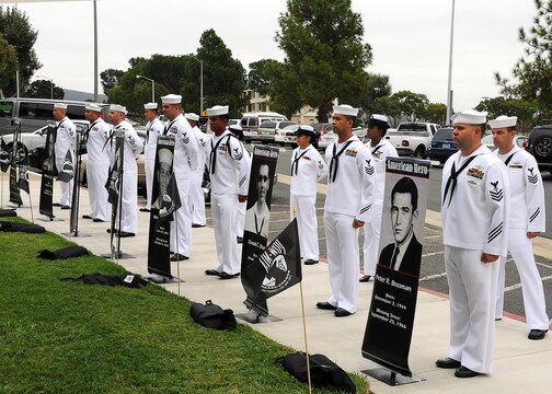 Sailors from the Naval Hospital Camp Pendleton 1st Class Petty Officers Association display the names and portraits of seven Navy hospital corpsmen still missing from the Vietnam War during a service of remembrance at the NHCP Prisoner of War/Missing in Action Memorial on National POW/MIA Recognition Day Sept. 20.   Naval Hospital Camp Pendleton held its 23nd annual Prisoner of War/Missing in Action Remembrance Ceremony on the front lawn of the hospital at the POW/MIA memorial site.   (U.S. Navy photo by Petty Officer 1st Class Michael R. McCormick)