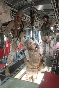 MARINE CORPS BASE CAMP PENDLETON, Calif. – Corporal Joseph E. Lechnar, squad leader, Kilo Company, 3rd Battalion, 5th Marine Regiment, steadies a rope as his Marine fast ropes out of a CH-46 Sea Knight helicopter during a training exercise here, Oct. 9, 2013. Fast roping allows Marines to quickly enter an area without the need for a landing zone. The technique is often employed during raids, enabling forces to rapidly secure an objective. The battalion is scheduled to deploy next spring as the battalion landing team for the 31st Marine Expeditionary Unit in Okinawa, Japan. Kilo Co. is currently assigned as the helicopter element within the battalion landing team.