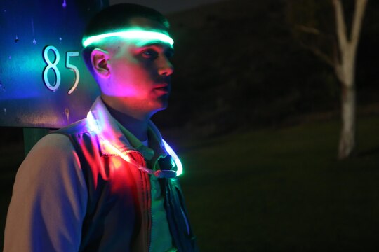 Cpl. Jordan Barker waits for his turn to tee off during the Glow-Ball tournament at the Marine Memorial Golf Course on base Oct. 25.The par three course was nine holes, dimly lit by neon lights at each hole and the lighted necklaces the participants wore. Barker is an Arabic cryptologic linguist with 1st Radio Battalion, 1st Marine Expeditionary Force.