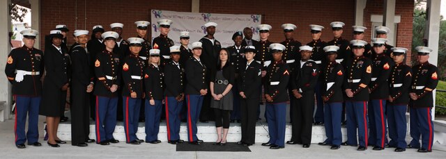 Service members stand together after the domestic violence candlelight vigil in downtown Jacksonville, Oct. 24. Sgt. Amanda King, keynote speaker and advocate for the Onslow Women’s Center, said as a survivor herself, she promotes others to speak out against domestic violence and seek help if they have been victimized.