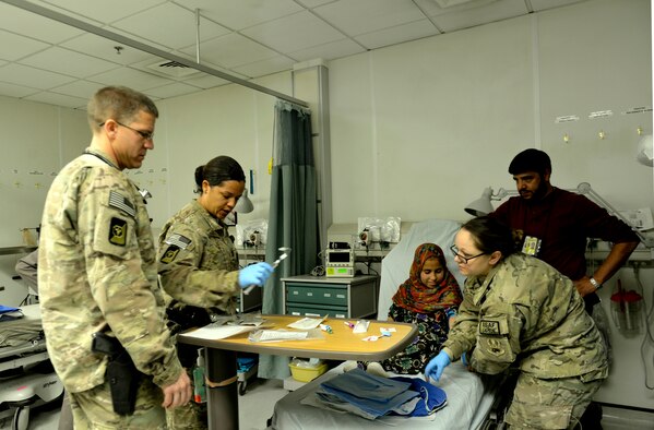 Lt. Col. David Jones, 455th Expeditionary Medical Group pediatrician and nurses conduct a pre-operation assessment and labs on a 12-year-old in the Craig Joint Theater Hospital on Bagram Airfield, Afghanistan, Oct. 20. The girl has a gastrointestinal blood vessel tumor. Jones is a native of San Antonio. (U.S. Air Force photo/ Staff Sgt. Stephenie Wade)