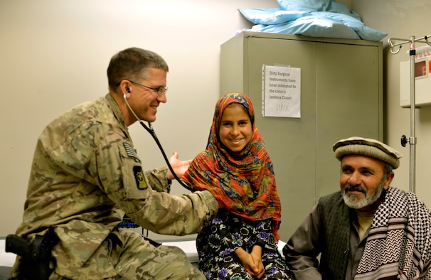 Lt. Col. David Jones, 455th Expeditionary Medical Group pediatrician, conducts a pre-operation exam on a 12-year-old girl in the Craig Joint Theater Hospital on Bagram Airfield, Afghanistan, Oct. 20. The girl has a gastrointestinal blood vessel tumor. Jones is a native of San Antonio. (U.S. Air Force photo/ Staff Sgt. Stephenie Wade) 
