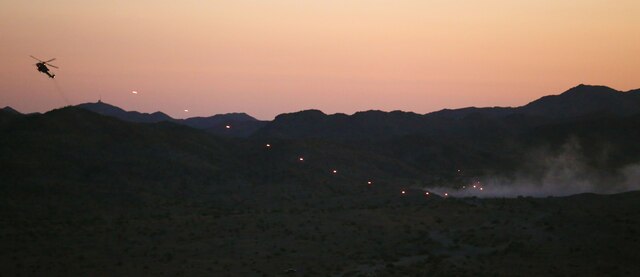 An AH-1Z super cobra helicopter circles around to a target for immediate fire drills at a range northwest of Marine Corps Air Station Yuma, Ariz., Aug. 15., during a night evolution in support of exercise Scorpion Fire and a team of joint terminal attack controllers with 3rd Air Naval Gunfire Liaison Company Marine Forces Reserve, based out of the Armed Forces Reserve Center in Bell, Calif. (Photo by Cpl. Uriel Avendano)