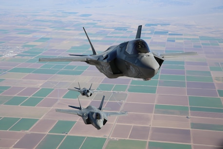 Three F-35B Lightning II Joint Strike Fighters with Marine Fighter Attack Squadron 121, 3rd Marine Aircraft Wing, fly in formation during fixed-wing aerial refueling training over eastern California, Aug. 27. VMFA-121 is the first F-35B squadron in the Marine Corps. (Photo by Lance Cpl. Michael Thorn)