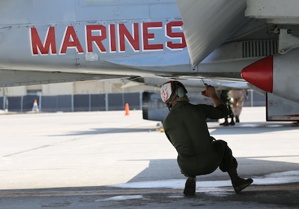 A power line mechanic with Marine Fighter Attack Squadron 232 preforms a maintenance check on an F/A-18C Hornet on the flight line aboard Mountain Home Air Force Base, Idaho, July 26.  Power line mechanics and other maintainers make sure every F/A-18C Hornet is ready and safe for flight.