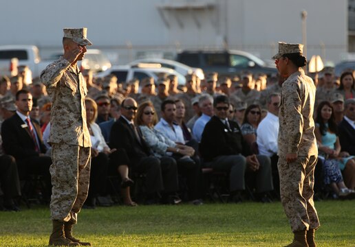 Sgt. Roberto Gonzalez, the reviewing officer for the ceremony with Marine Wing Support Squadron 373, salutes the commander of troops during an evening colors ceremony hosted by 3rd Marine Aircraft Wing and Marine Corps Air Station Miramar aboard the air station, Sept. 11.  The ceremony was held in memory of the victims of the 9/11 terrorist attacks and the attack on Camp Bastion, Afghanistan Sept. 14, 2012.