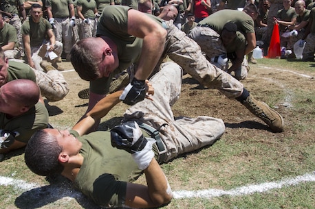 Lance Cpl. Cory Helton, top, a power lines mechanic with Marine Fighter Attack Squadron 232 and Whitley County, Ky., native, grapples with another Marine during the Kings and Queens of the Ring event at the first Marine Aircraft Group 11 field meet aboard Marine Corps Air Station Miramar, Calif., Aug. 22. Marines throughout MAG-11 competed in different events to win the MAG-11 trophy for their squadron.