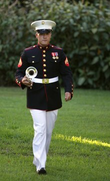 Cpl. Brian Navin, a trumpet player for the U.S. Marine Corps Forces, Pacific Band, marches out to play “First Call,” a courtesy signal prior to the ceremony, Sept. 15. Lt. Gen. Terry G. Robling, MarForPac commander, and his wife, Cathe Robling, hosted a centennial ceremony for the “Chesty Puller House” and neighboring homes, which were completed in 1913.