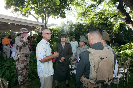 Sgt. Maj. William R. Sweet, Sergeant Major of Headquarters and Service Battalion, U.S. Marine Forces, Pacific, talks to Uniform Pageant Marines at the “Chesty Puller House” here, Sept. 15. The Marines were dressed in the different uniforms that had been worn throughout the home’s 100-year history.