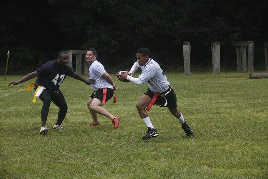 A defensive lineman with Weapons Training Battalion tries to tackle the Marine Special Operations Combat Support Battalion quarterback during the flag football tournament aboard Stone Bay Rifle Range, Sept. 21.