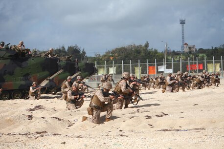 Marines take firing positions Sept. 18 on the beach at Camp Schwab as part of an amphibious assault. Amphibious operations continue to be a pillar of the United States Marine Corps’ mission, according to 1st Lt. Jonathan M. Brown, a platoon commander with Assault Amphibious Vehicle Company, Combat Assault Battalion. Approximately 150 Marines and sailors with Weapons Company, 3rd Battalion, 3rd Marine Regiment, were transported from the USS Ashland to shore via AAVs. The service members with Weapons Company are currently assigned to 4th Marines, 3rd Marine Division, III Marine Expeditionary Force, under the unit deployment program. The AAVs are assigned to AAV Co., CAB, 3rd Marine Division, III MEF.