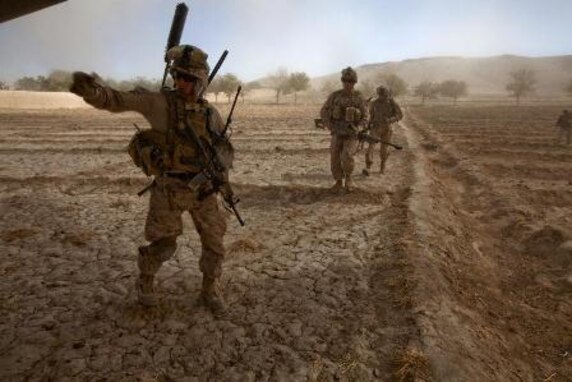 U.S. Marines with Bravo Company, 1st Battalion, 9th Marines (1/9) run towards a CH-53E Super Stallion assigned to Marine Heavy Helicopter Squadron 462 (HMH-462) at Gurjat Village, Helmand province, Afghanistan, Oct. 28, 2013. HMH-462 provided aerial support for 1/9 during an interdiction operation. (U.S. Marine Corps photo by Sgt. Gabriela Garcia/Released)