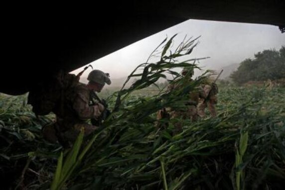 U.S. Marines with Golf Company, 2nd Battalion, 8th Marines, Regimental Combat Team 7 and Afghan National Security Forces, run out of a CH-53E Super Stallion aircraft, assigned to Marine Heavy Helicopter Squadron 461 (HMH-461), in the Helmand province, Afghanistan, Aug. 20, 2013. HMH-461 provided aerial support for Marines with Golf Company, 2nd Battalion, 8th Marines, Regimental Combat Team 7 and Afghan National Security Forces during an International Security Assistance Force and North Atlantic Treaty Organization operation. (U.S. Marine Corps photo by Sgt. Gabriela Garcia/Released)