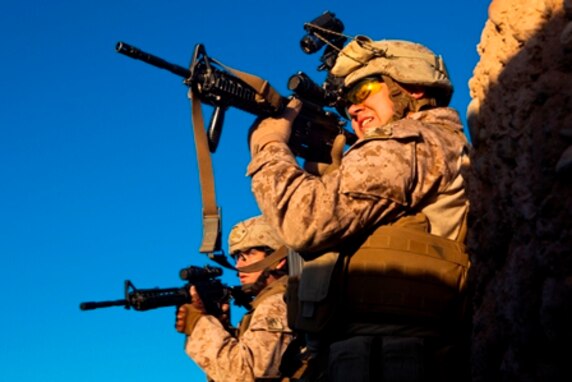 Lance Cpl. Brandon Bowker, a Roberta, Ga., native and rifleman with 1st Battalion, 9th Marines, scans the desert for threats during a firefight with insurgents near the Bari Gul Bazaar, Nad Ali District, Helmand province, Afghanistan, Dec. 4, 2013. Nearly 100 Marines and coalition allies engaged in a prolonged firefight with insurgents while patrolling the area to interdict Taliban movements and weapons caches and gather intelligence around the bazaar. The interdiction force landed by helicopter during the cover of night and began sweeping through the area with the help of Afghan forces and interpreters before engaging Taliban fighters in a firefight that lasted nearly four hours. 