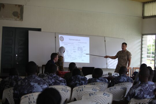 Lance Cpl. Tyler Jackson, a Marine with Special-Purpose Marine Air-Ground Task Force Africa 14.1, presents a class on small-boat engine mechanics to a class of sailors from the Togolese Navy, in Lomé, Togo, March 25. Jackson, a Lancaster, Calif., native, was responsible for creating classroom instructions and practical application courses designed to show the Togolese sailors the best common practices to fix the engines on their fleet of boats.
