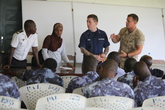 Lance Cpl. Tyler Jackson, a Marine with Special-Purpose Marine Air-Ground Task Force Africa 14.1, and Petty Officer 3rd Class Brian Spence, a Coastguardsman with U.S. Coast Guard Station Seattle, inspect a boat engine prior to starting a week-long training program designed to demonstrate proper small-boat engine mechanics to a group of sailors from the Togolese Navy in Lomé, Togo, March 24. Jackson and Spence put together a week-long training program of classroom instruction and practical application so the two groups of service members could partner together to fix engines. Established in 2011, Special-Purpose Marine Air-Ground Task Force Africa 14.1 is charged with supporting U.S. Africa Command and Marine Corps Forces Europe and Africa’s theater security cooperation requirements.