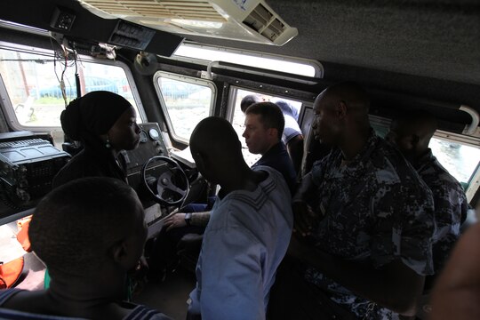 A group of sailors with the Togolese Navy watches as Petty Officer 3rd Class Brian Spence, a Coastguardsman with U.S. Coast Guard Station Seattle, demonstrates how to properly diagnose engine problems from within the cockpit of a small boat in Lomé, Togo, March 25. Spence put together a week-long training program of classroom instruction and practical application so the two groups of service members could partner together to fix engines. Established in 2011, Special-Purpose Marine Air-Ground Task Force Africa 14.1 is charged with supporting U.S. Africa Command and Marine Corps Forces Europe and Africa’s theater security cooperation requirements.