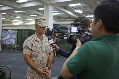 Staff Sgt. Ross Larson, a combat engineer with 7th Engineer Support Battalion, attached to Special Purpose Marine Air-Ground Task Force Association of South East Asian Nations, briefs international media personnel on the MAGTF’s humanitarian aid capabilities during a static display aboard amphibious transport dock ship USS Anchorage (LPD 23) in support of the ASEAN conference held by U.S. Secretary of Defense Chuck Hagel in Hawaii, April 2, 2014. Delegates and media personnel, from 10 Southeast Asian countries, attended the exhibit to learn more about the Navy and Marine Corps’ humanitarian aid and disaster relief capabilities. As subject matter experts with firsthand experience on their equipment, the Marines and sailors who participated were able to increase the international public’s understanding of what the Navy-Marine Corps team can do during disaster situations, and built rapport with foreign officials and militaries. 