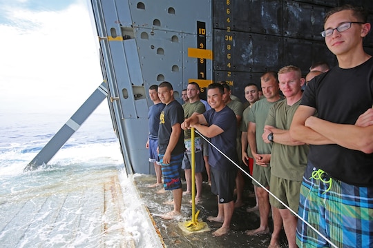Marines and sailors with Special Purpose Marine Air Ground Task Force Association of Southeast Asian Nations participate in a Swim Call - allowing them to swim in a small area behind the ship, secured by lifeboats and a safety line aboard amphibious transport dock ship USS Anchorage (LPD 23), April 11, 2014. Swimming in the sea, more than a thousand miles away from land, provided the Marines and sailors with a physically intensive but unique experience. The event was one of many recreational events held with SPMAGTF-ASEAN to relieve stress and build unit cohesion. SPMAGTF-ASEAN, aboard Anchorage, recently completed a mission to support U.S. Secretary of Defense Chuck Hagel during a press conference with delegates and media personnel from the ASEAN in Hawaii, April 1-4, 2014 and is currently at sea conducting further training and maintenance on equipment.